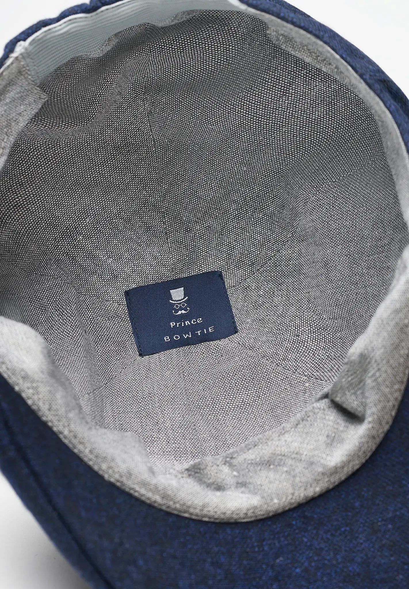 (Dunkelblau) Schiebermütze Tweed – Innenseite mit Prince Bowtie Label